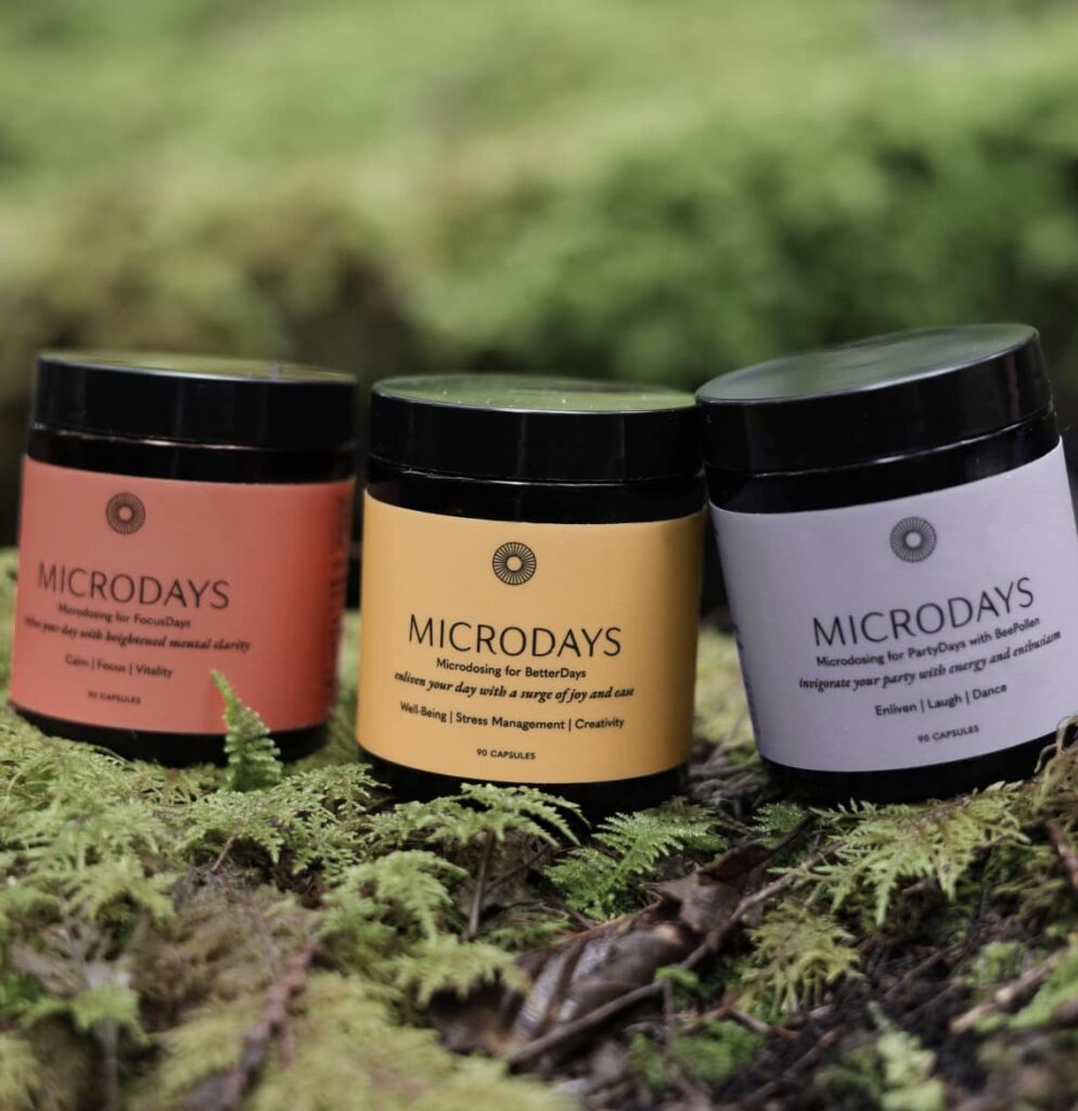 FocusDays, BetterDays and PartyDays microdose capsule jars on a mossy forest floor